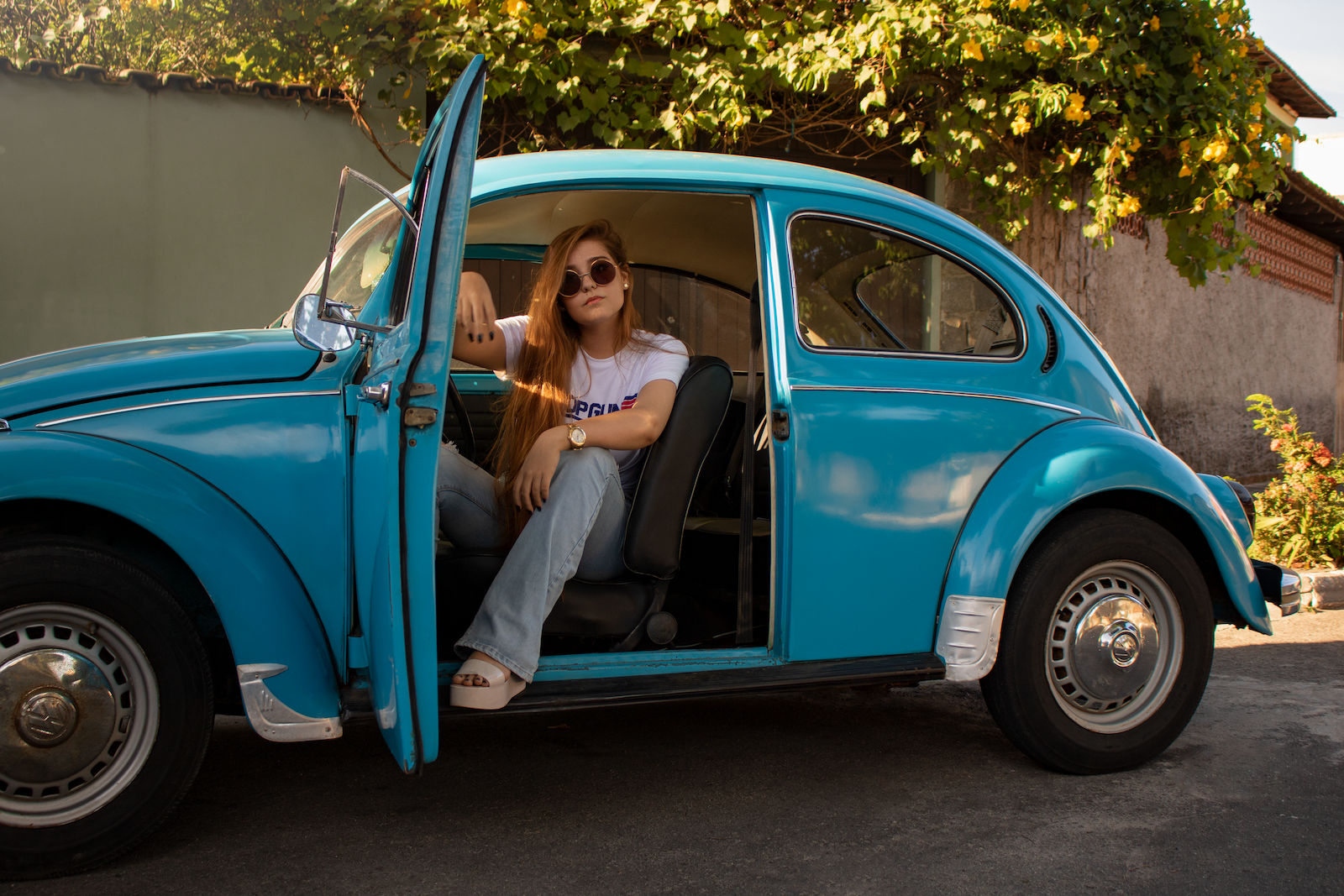 vw beetle, Woman Wearing White Shirt Sitting Inside Blue Volkswagen Beetle