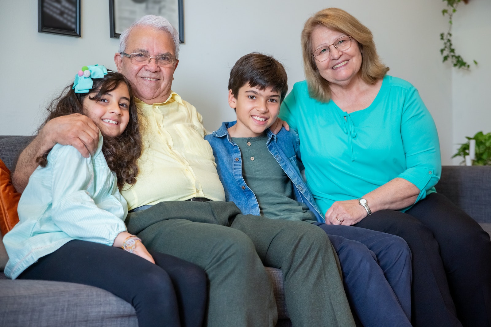 Connecting with grandchildren, Woman in Blue Shirt Sitting Between 2 Women