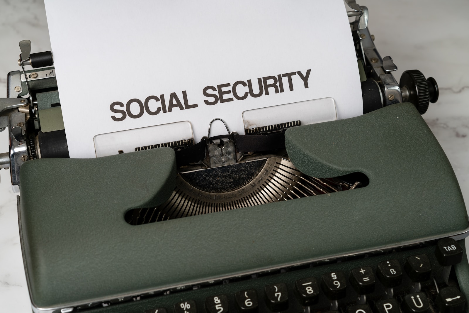 a close up of a typewriter with a paper that says social security
