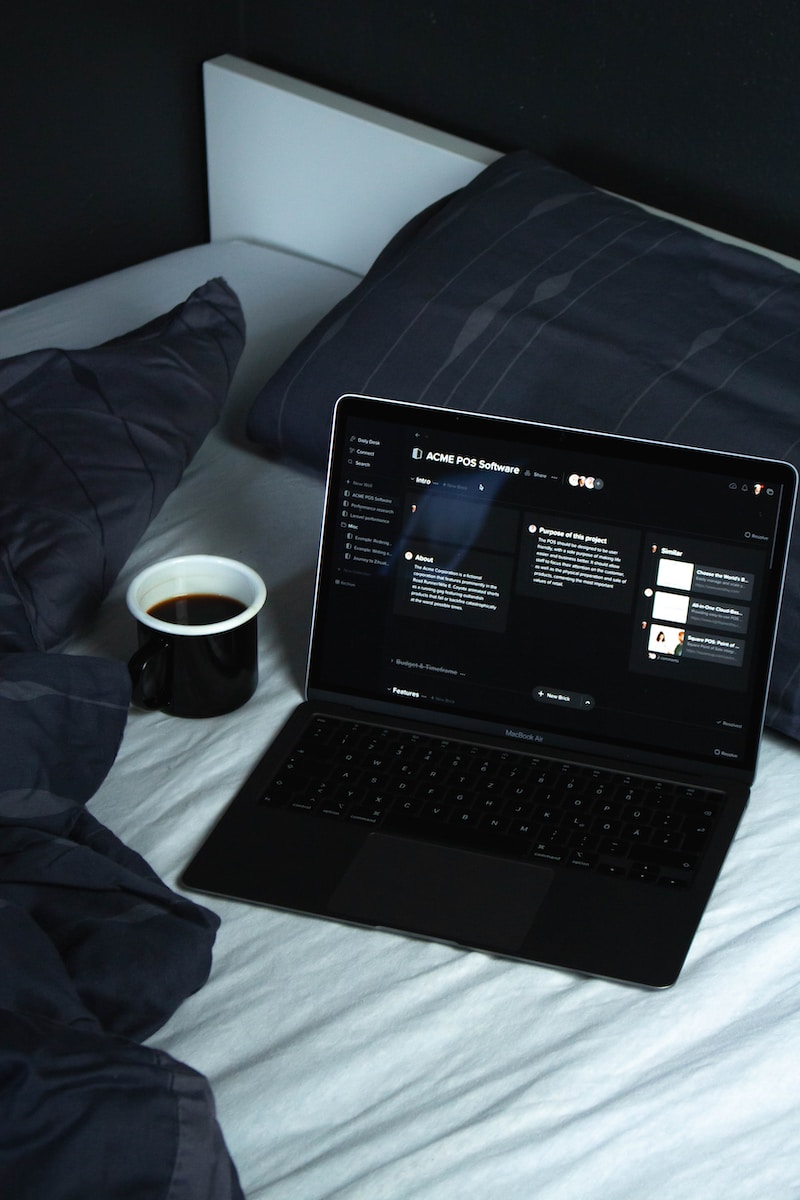 dark mode, black laptop computer on white bed